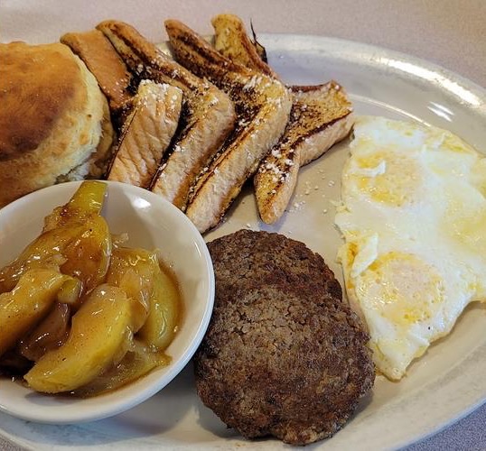 French toast with fried apples, sausage, eggs and a biscuit