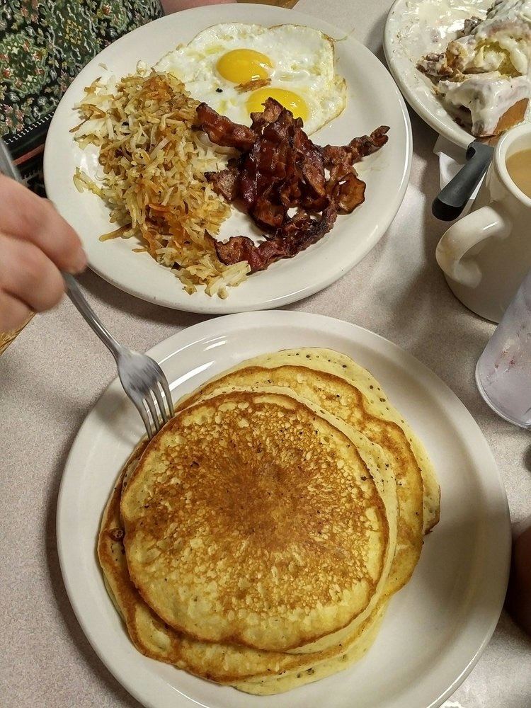 Pancakes with eggs, bacon and hash browns